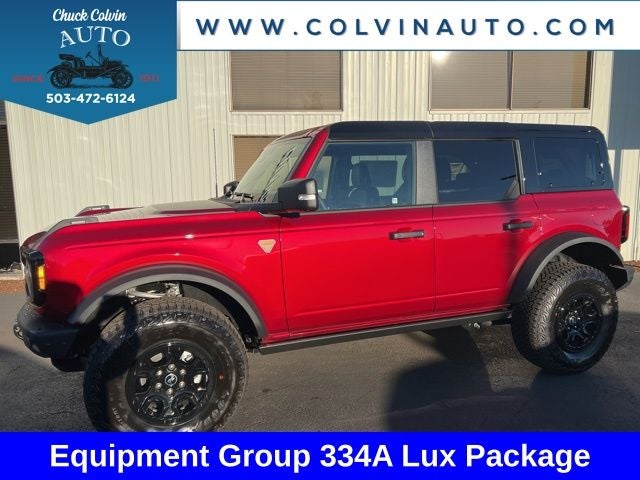 2025 Ford Bronco Badlands in Ruby Red Metallic Tinted Clearcoat — front three-quarter view